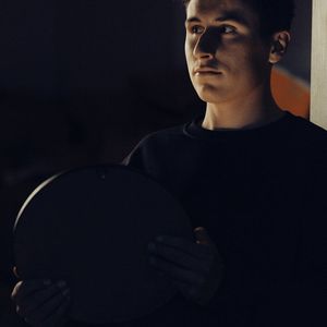 Shadow of a person training against a dark wall.